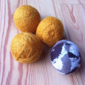 four finished wool balls